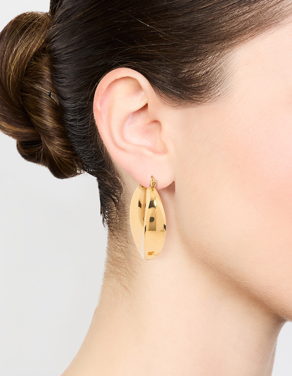 Showcasing waterproof gold plated stainless steel large hoop earrings on ear view