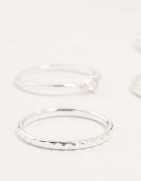 Highlighting silver plated dainty diamante stacking rings 5-pack with textured band close up view - link has visual effect only