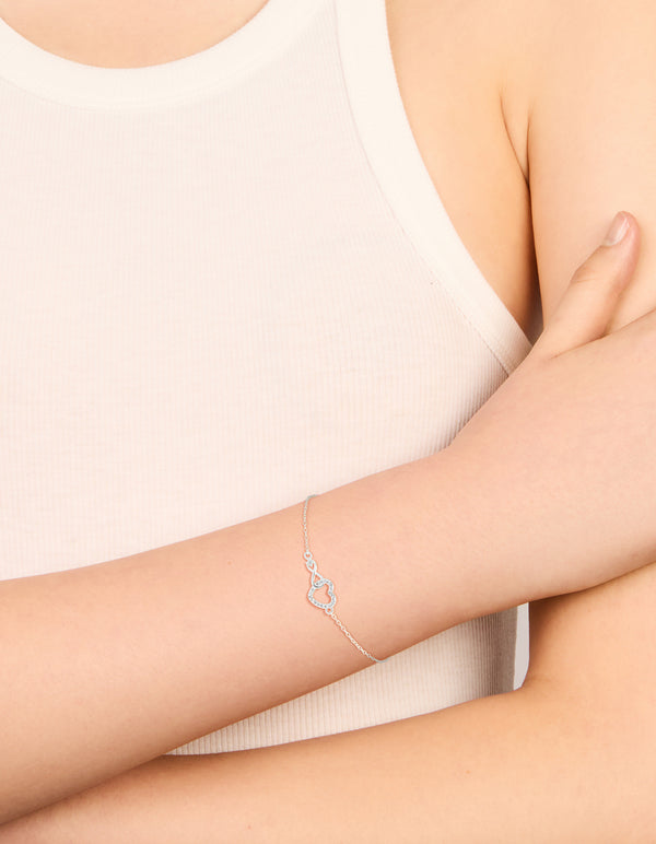 Elegantly designed sterling silver infinity and cubic zirconia heart link bracelet in silver on wrist view
