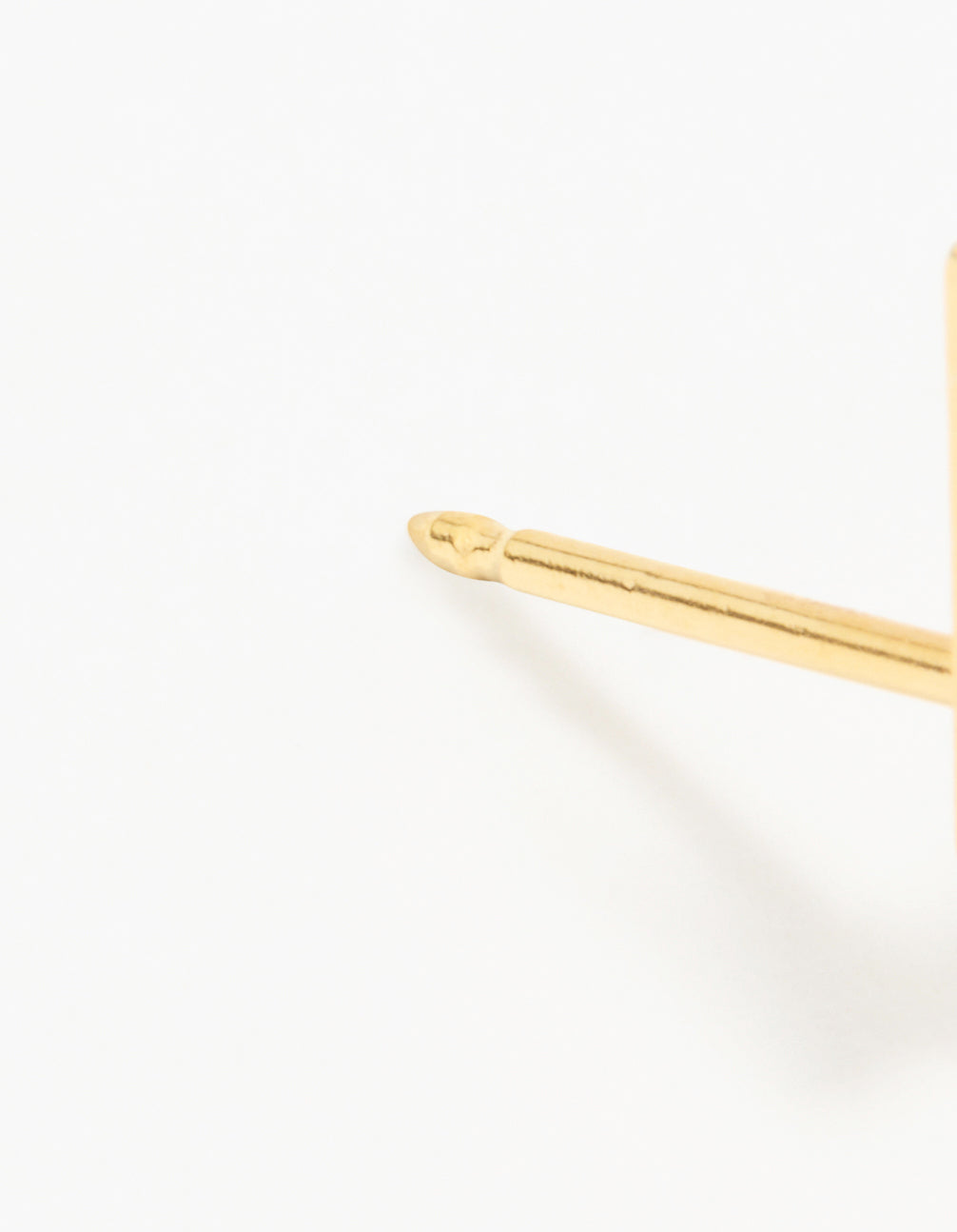 Highlighting a 24K gold plated surgical stainless steel lightning bolt piercing stud with closure detail view