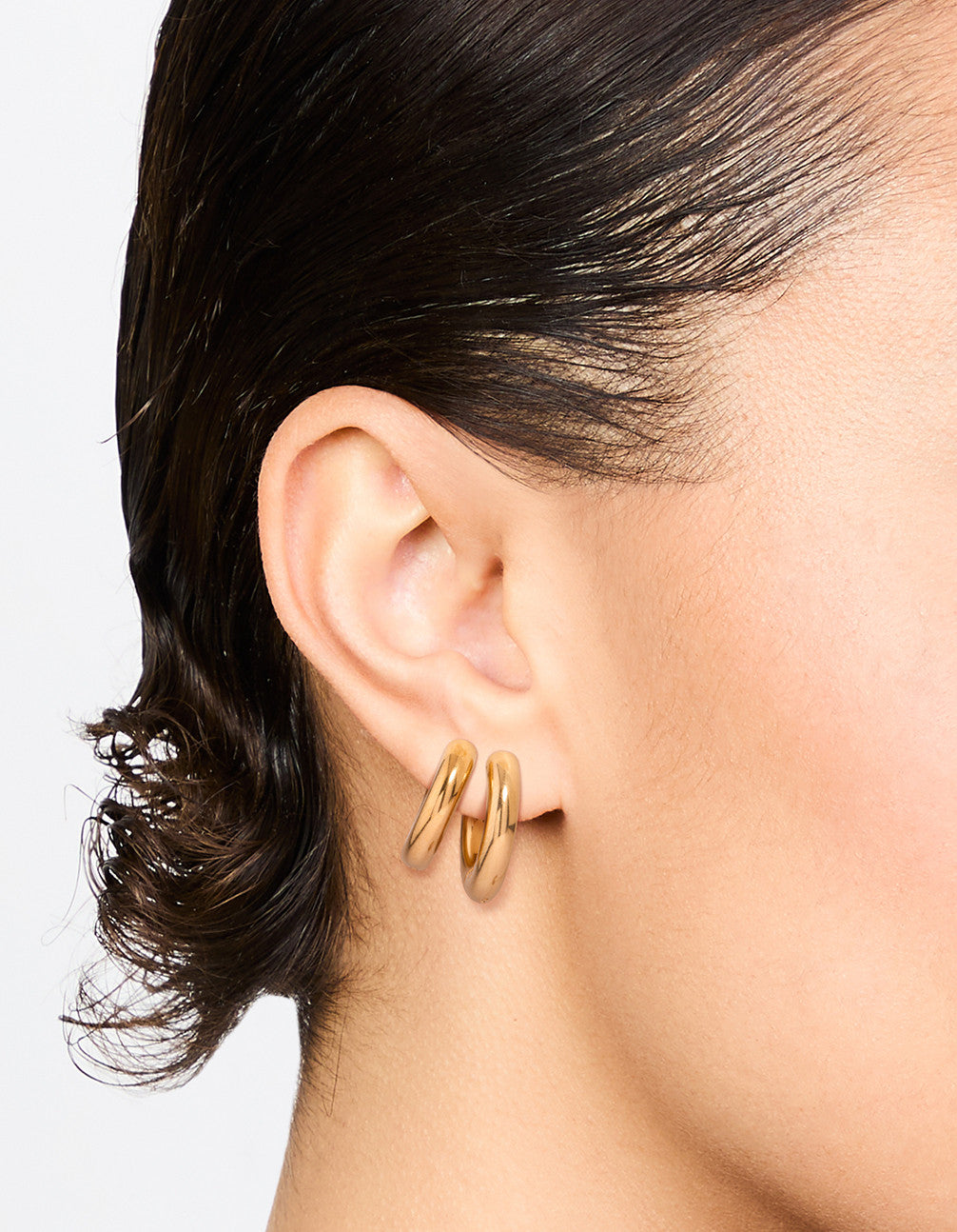 Featuring waterproof gold plated stainless steel tube hoop earrings in a 2 pack on ear view