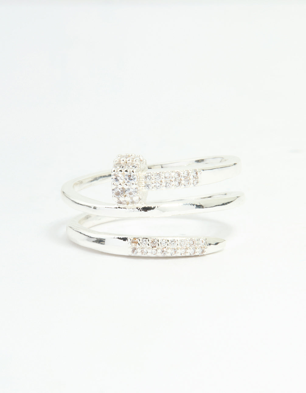 Highlighting a statement nail wrap ring crafted from silver plated metal, featuring cubic zirconia stones close up view