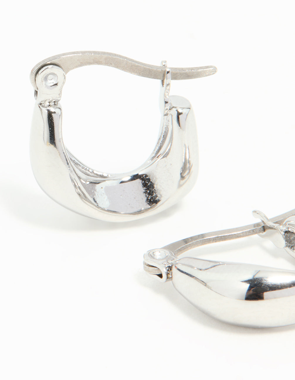 Displaying waterproof gold plated stainless steel organic twisted hoop closure mechanism close up view