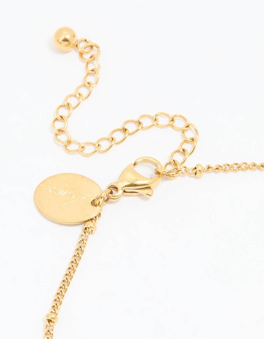 Designed with waterproof gold plated stainless steel, this dainty anklet features heart charms and ball accents in gold detail view