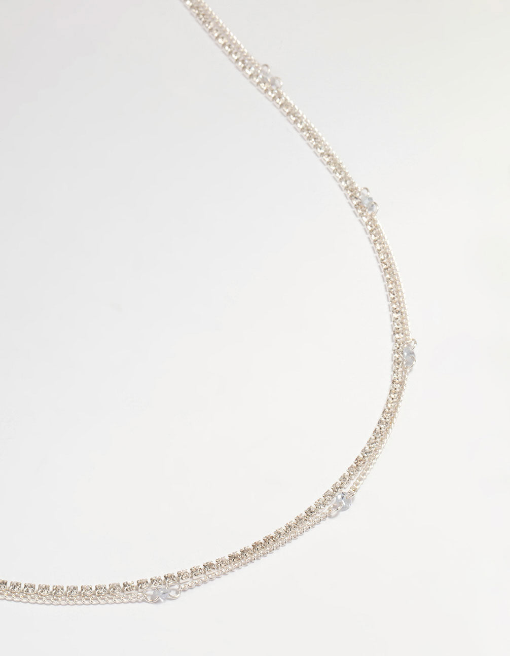 Showcasing a silver diamante cupchain waist chain embellished with beads and waisted shape detail view