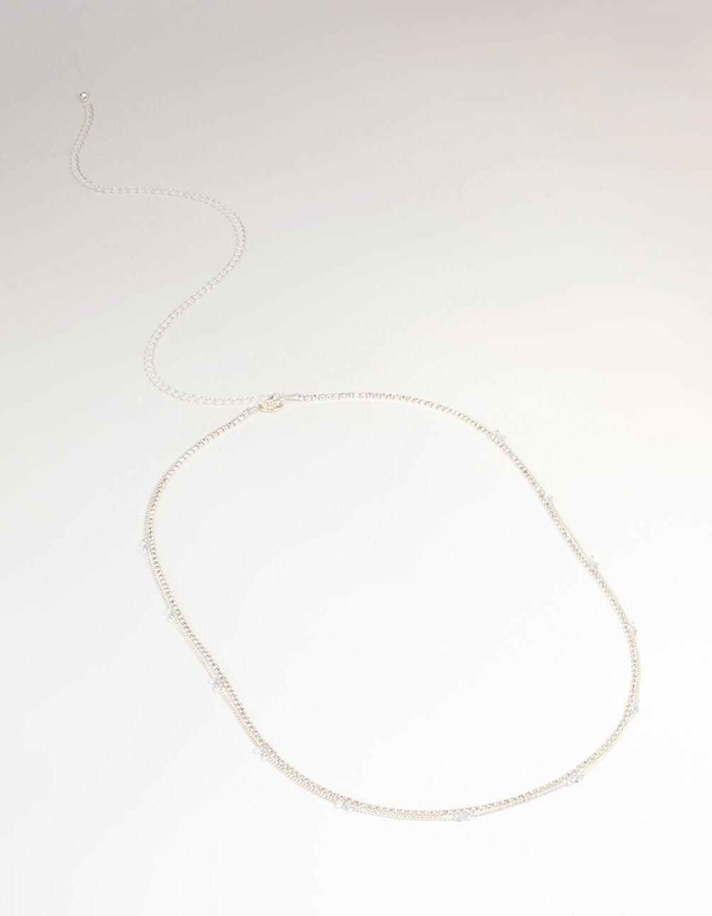 Featuring a silver diamante cupchain waist chain embellished with beads and waisted shape front view
