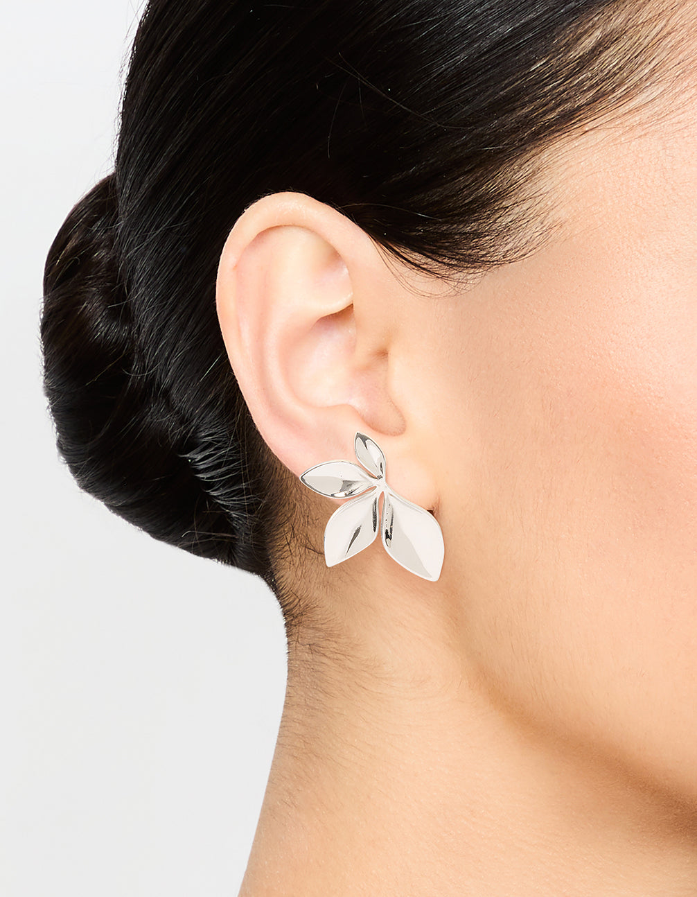 Designed with waterproof stainless steel leaf cluster stud earrings in silver on ear view