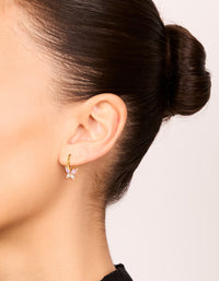 Stylish gold plated surgical steel butterfly sleeper earrings with pink cubic zirconia on ear view - link has visual effect only