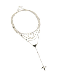 Featuring a layered necklace with beads, cross and heart in silver close up view - link has visual effect only