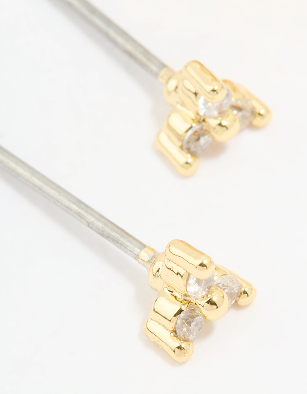 Highlighting gold plated cubic zirconia stud and huggie earrings in a 2-pack close up view