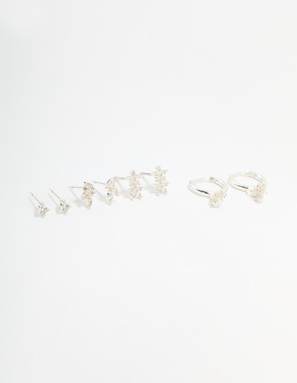 Showcasing a flower stud and hoop earrings 4-pack featuring floral patterns crafted from cubic zirconia, crystal, and silver plated brass with stud, huggie closures in white front view