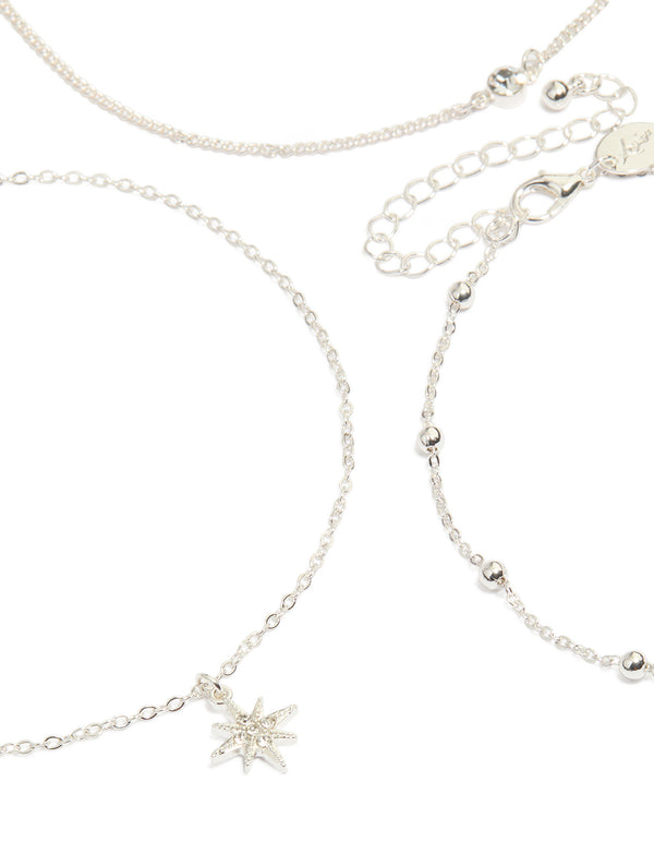 Showcasing a silver celestial choker necklace 6-pack with moon, star and balls close up view