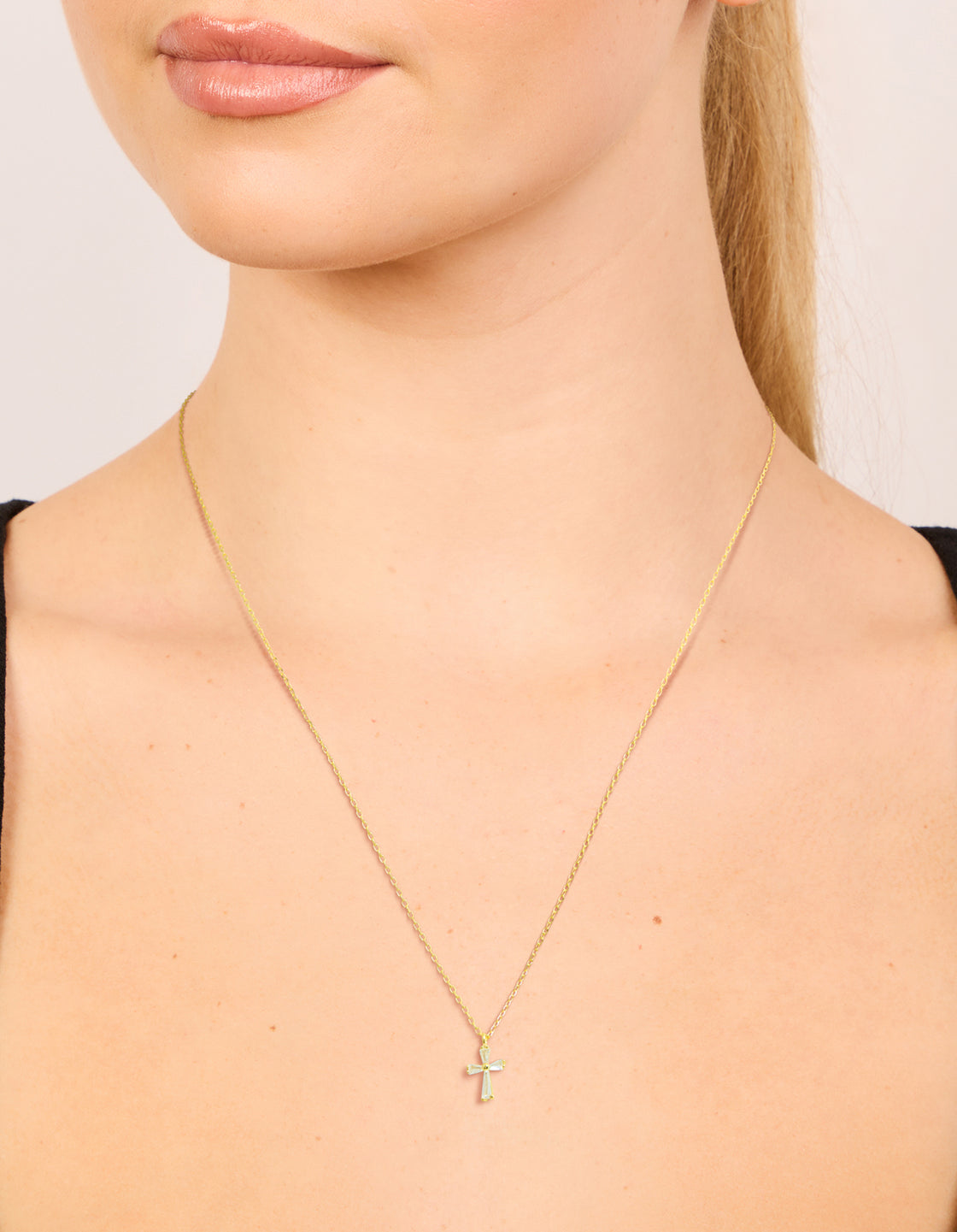 Elegant gold plated sterling silver cubic zirconia cross necklace on neck view
