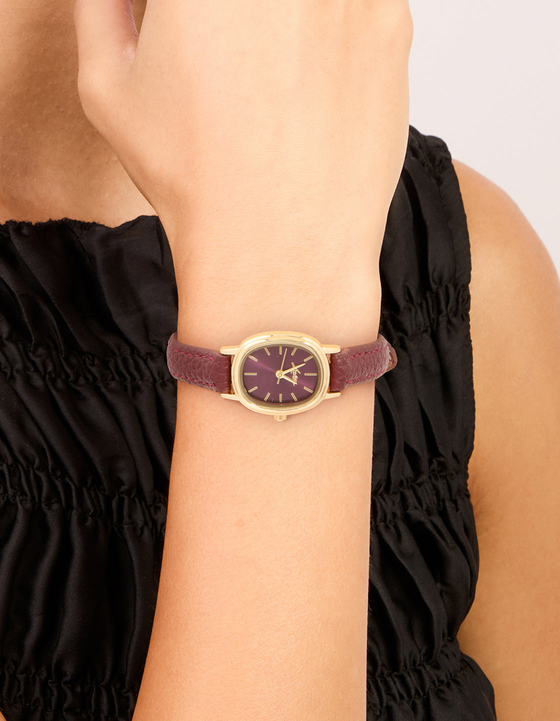 Showcasing a brown dial and leather strap designed for women, this gold burgundy PU leather oval watch with analog display is perfect for formal occasions on wrist view
