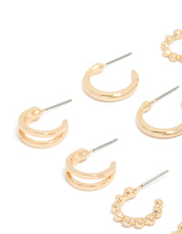 Featuring dainty hoop earrings in a 6-pack set in gold finish close up view - link has visual effect only