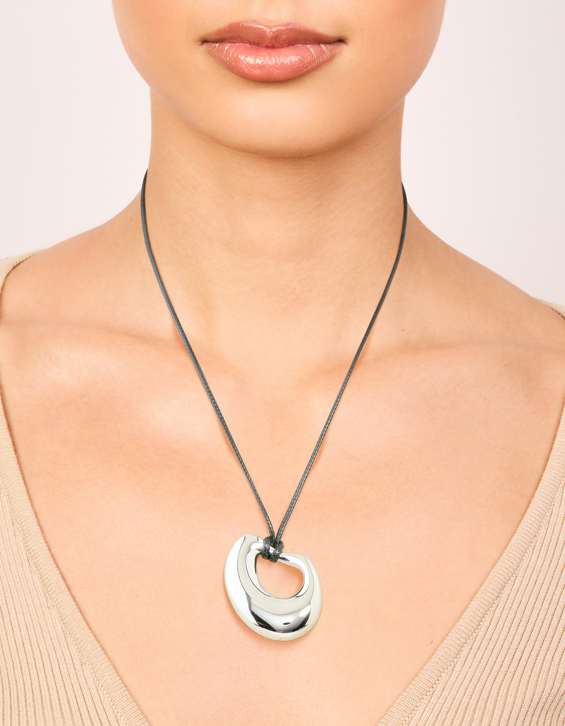 Featuring a waterproof stainless steel open molten pendant cord necklace in silver and dimgrey on neck view