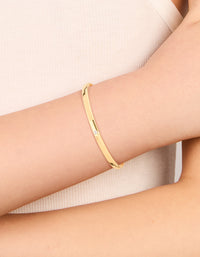 Showcasing a waterproof smooth open wrist cuff crafted from gold plated stainless steel with dainty style on wrist view - link has visual effect only
