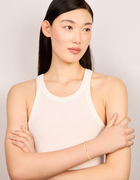 Featuring a waterproof smooth open wrist cuff crafted from gold plated stainless steel with dainty style on model view - link has visual effect only