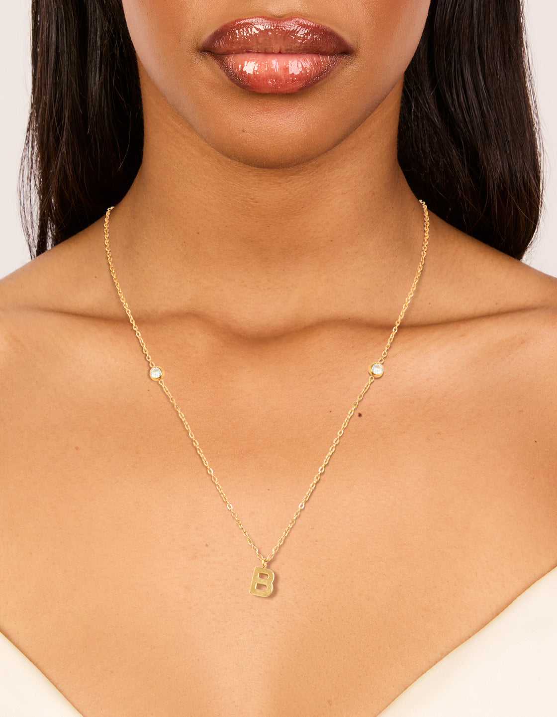 Showcasing a waterproof letter B initial pendant necklace in dainty gold plated stainless steel on neck view