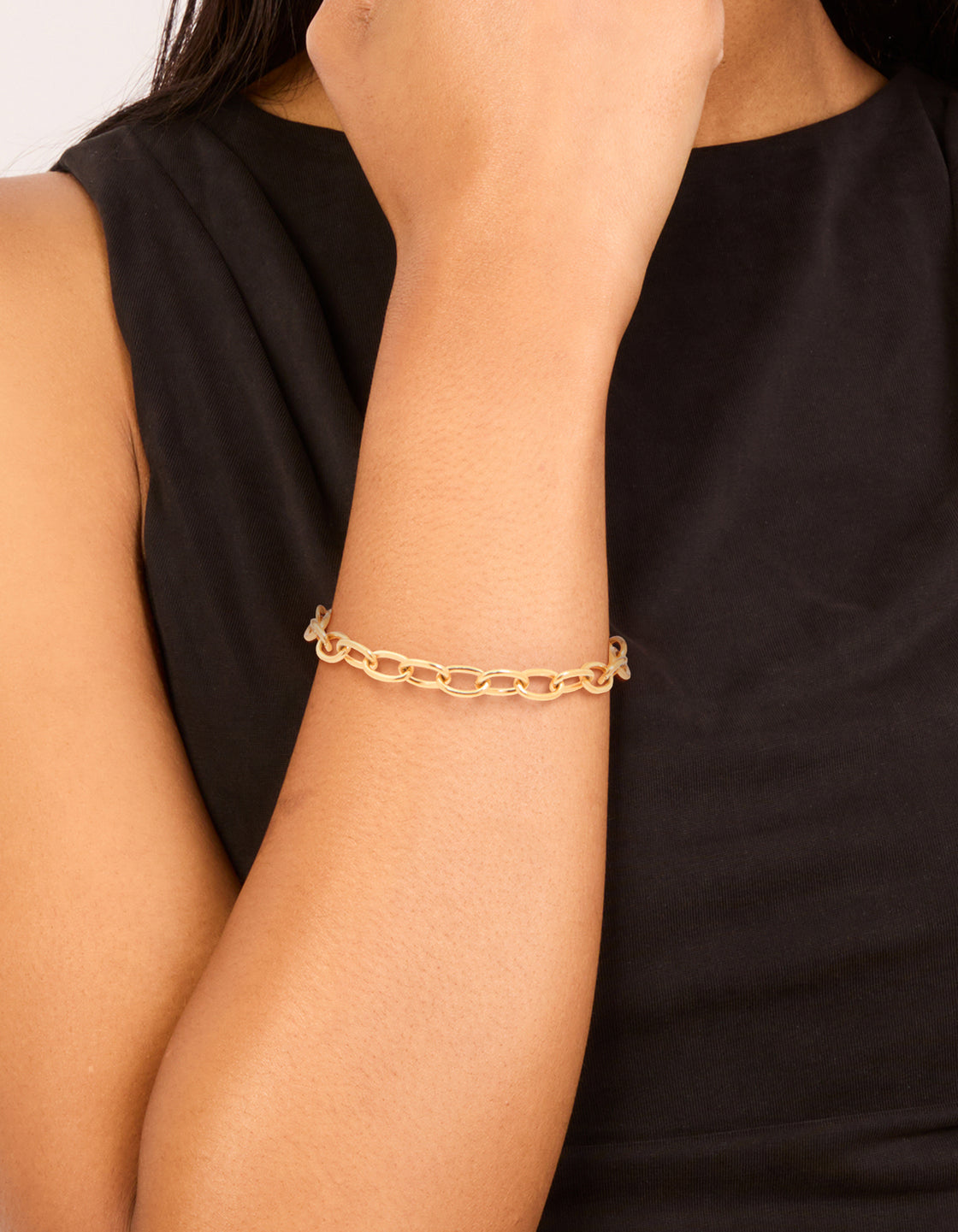 Showcasing a waterproof gold plated stainless steel dainty clasp chain bracelet on wrist view