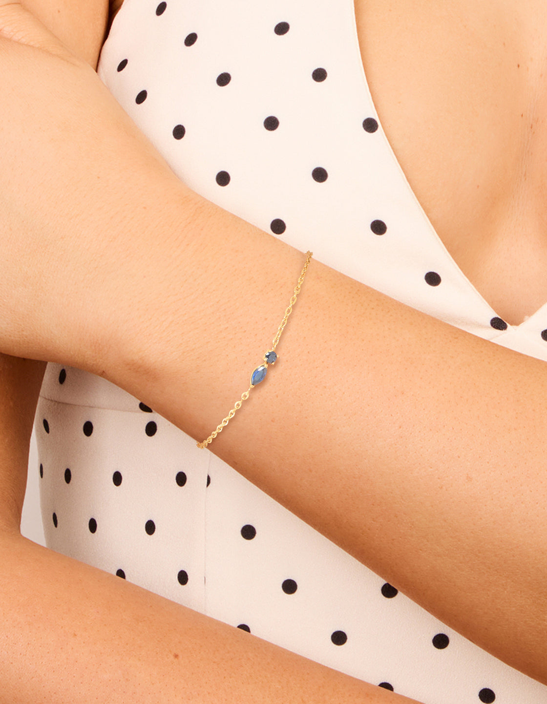 Showcasing a waterproof gold plated stainless steel September blue cubic zirconia birthstone bracelet on wrist view