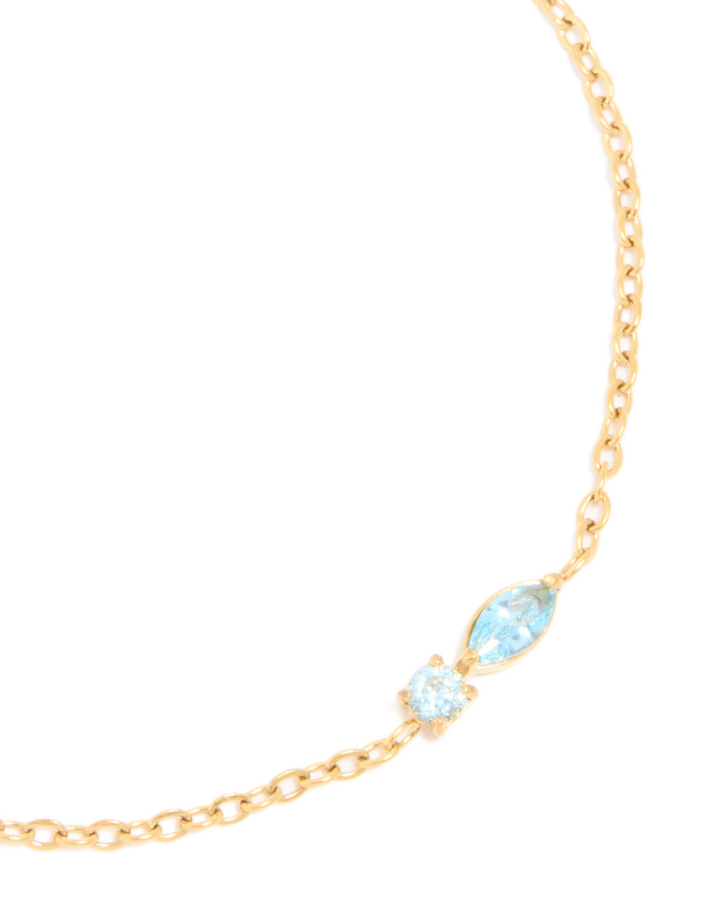 Elegantly crafted waterproof bracelet in gold plated stainless steel with light blue cubic zirconia close up view