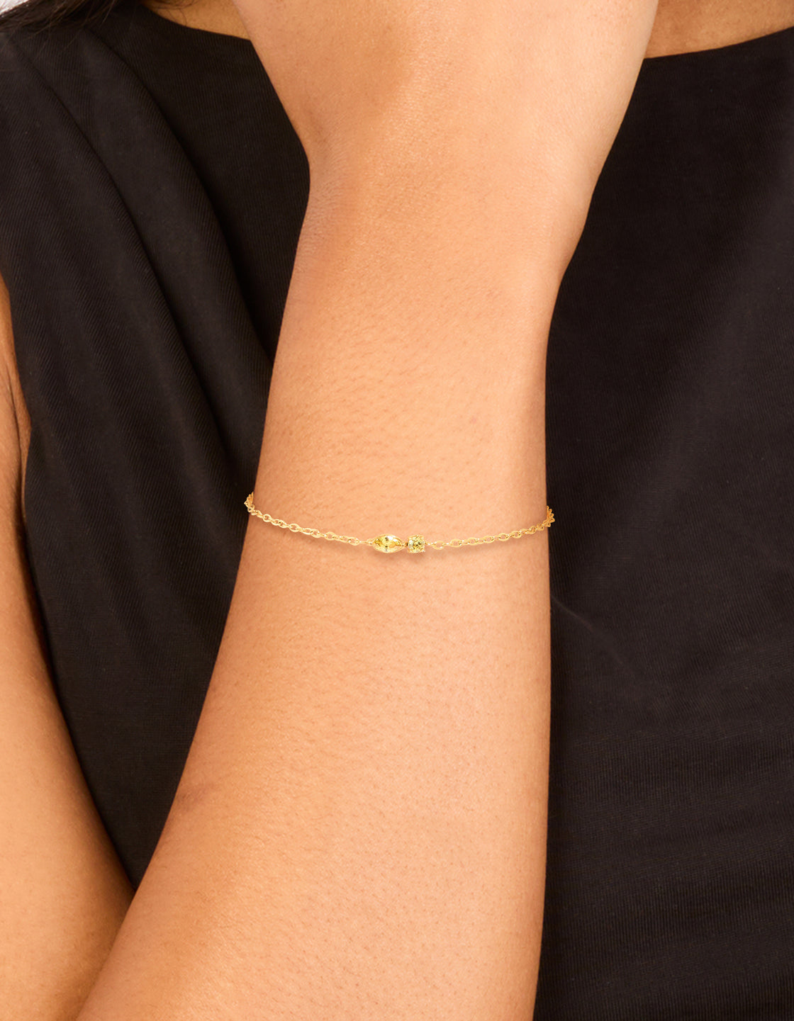 Designed with waterproof gold plated stainless steel and cubic zirconia, this November birthstone bracelet displays delicate yellow styling on wrist view