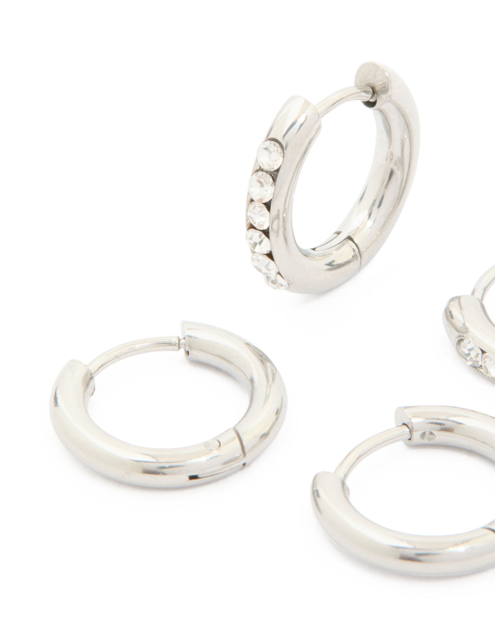 Designed with waterproof stainless steel, cubic zirconia and smooth chunky huggie earrings 2-pack featuring crystal embellishments in silver close up view