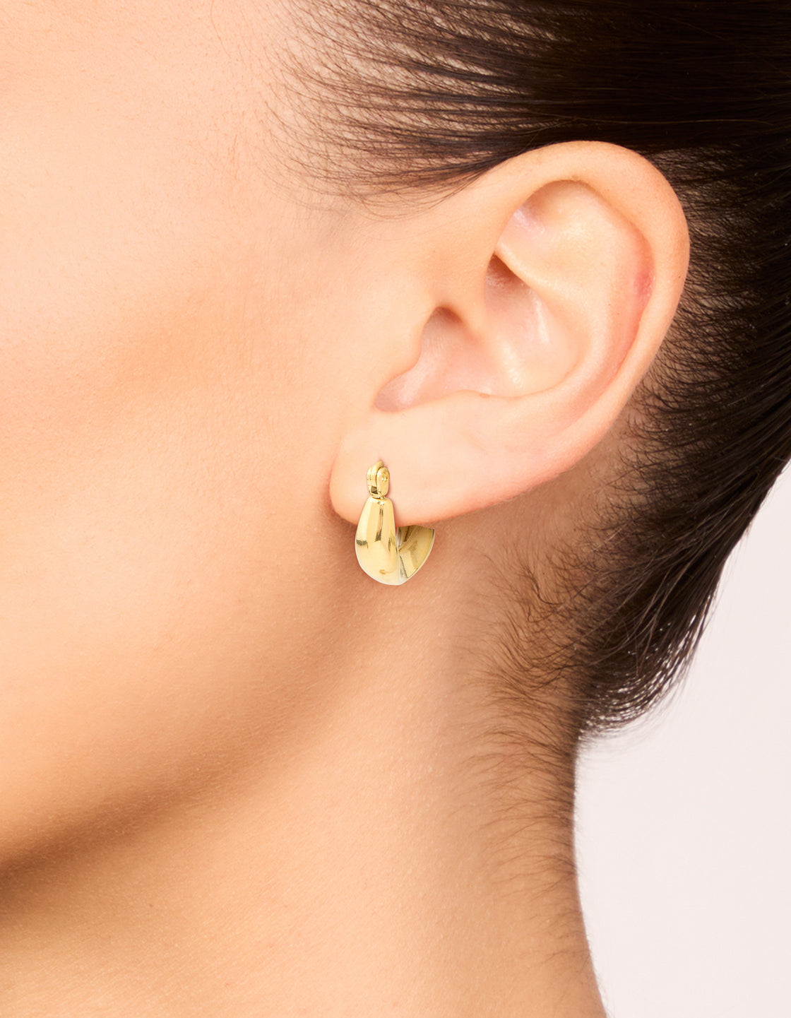 Featuring waterproof gold plated stainless steel organic teardrop hoop earrings on ear view