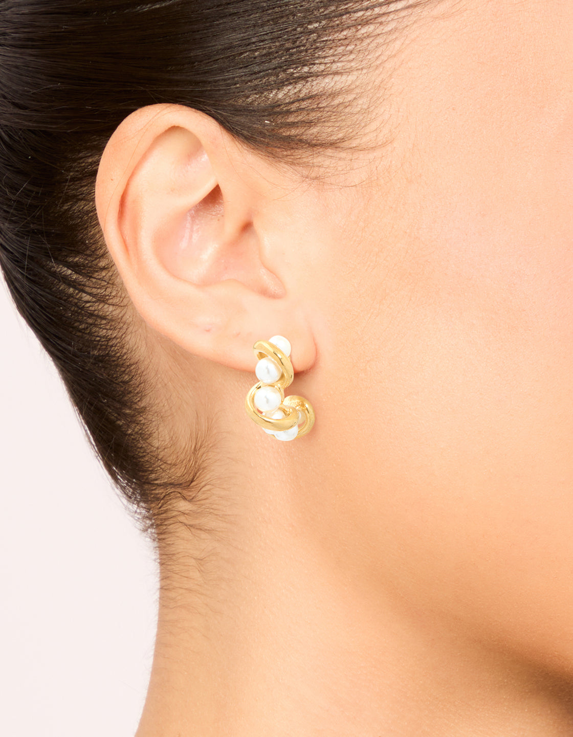 Elegant waterproof gold plated stainless steel pearl wire hoop earrings worn on ear view