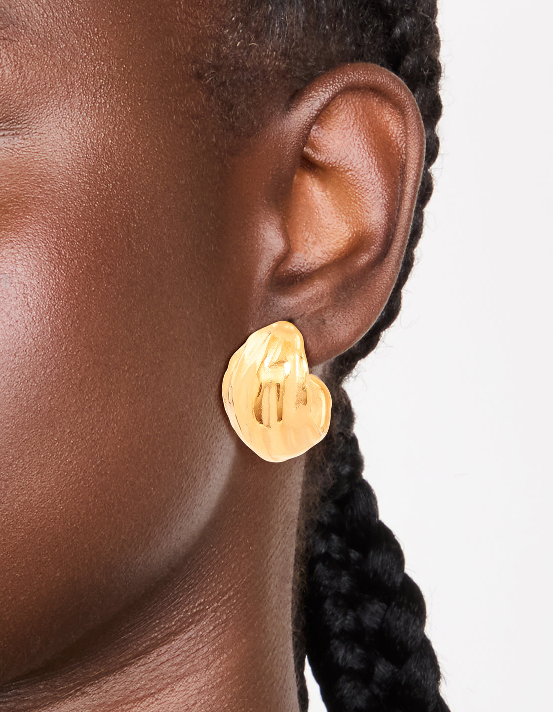 Waterproof gold plated stainless steel curved hoop earrings with chunky design on ear view