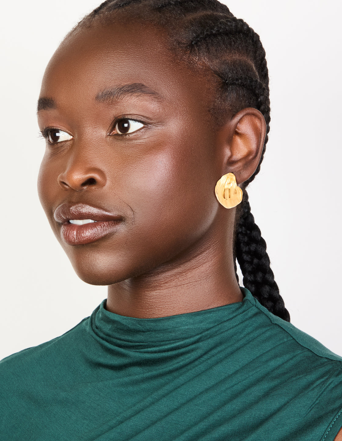 Featuring waterproof gold plated stainless steel, these chunky curved hoop earrings shown on model view