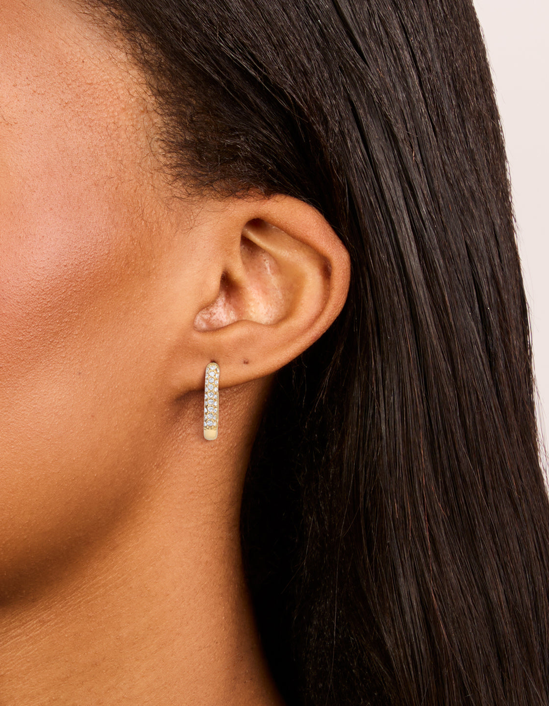 Featuring waterproof gold plated stainless steel diamante half oval hoop earrings on ear view
