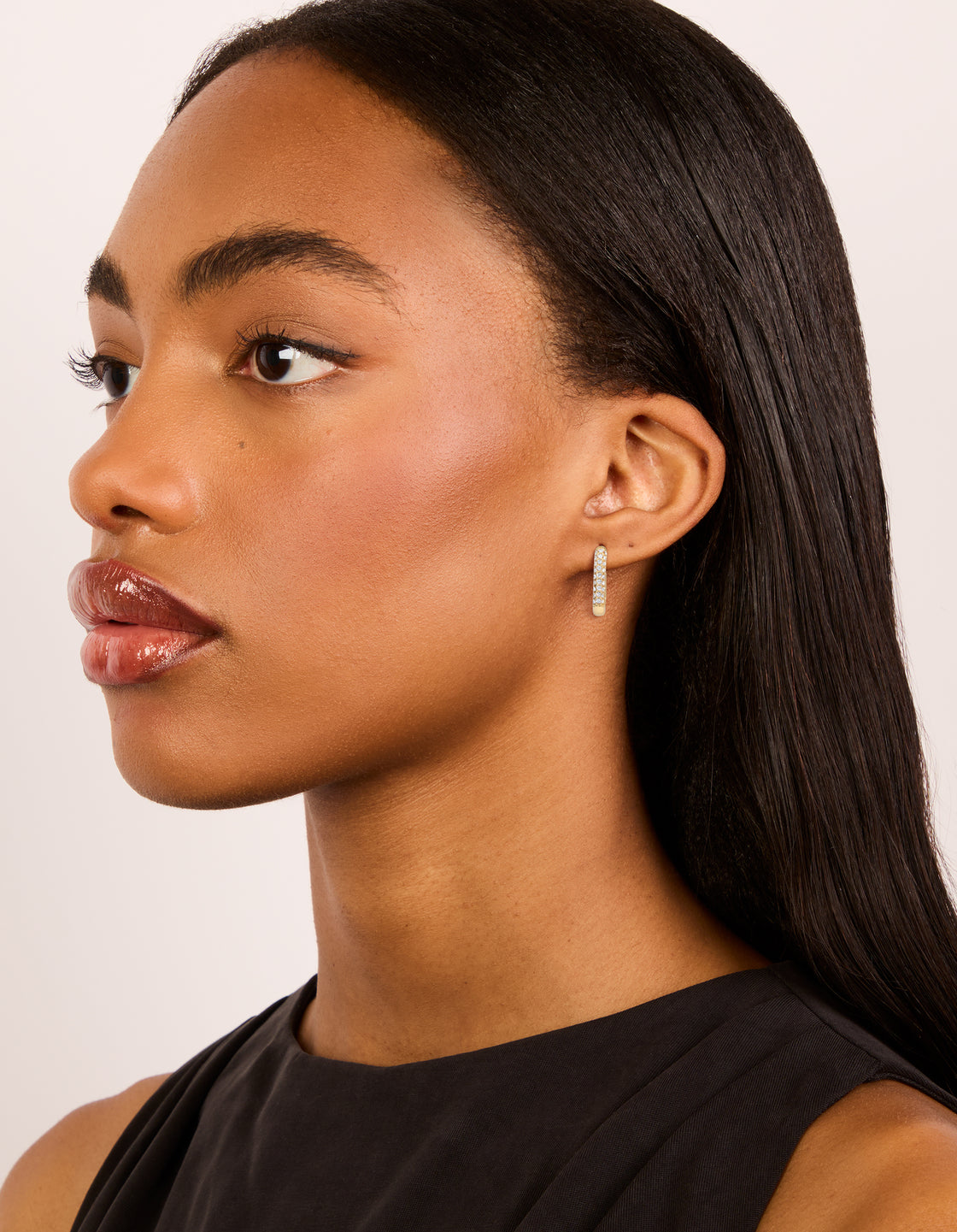 Crafted from waterproof gold plated stainless steel diamante half oval hoop earrings on model view