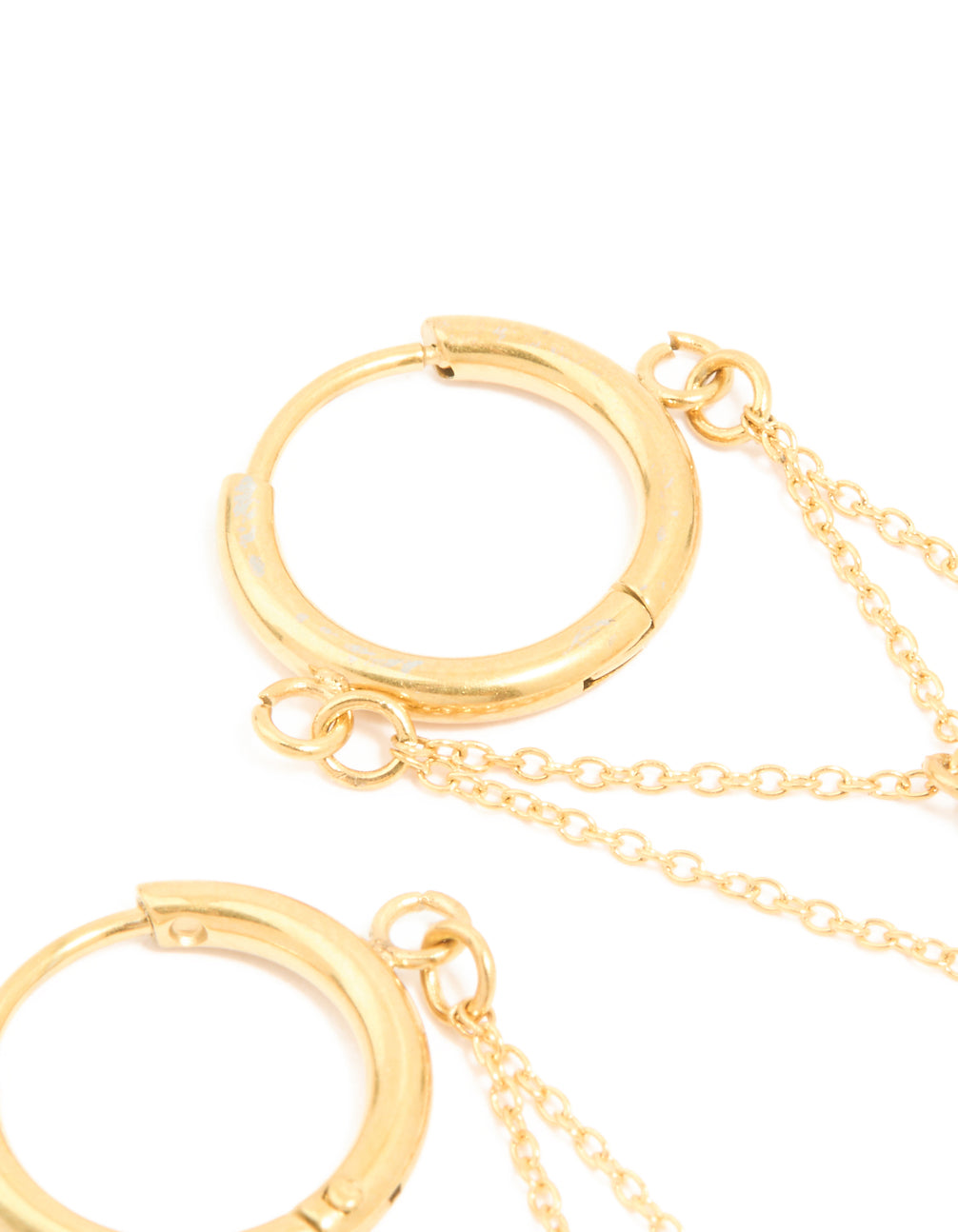 Displaying waterproof gold plated stainless steel huggie earrings and cubic zirconia elements, huggie closure in light blue post detail view