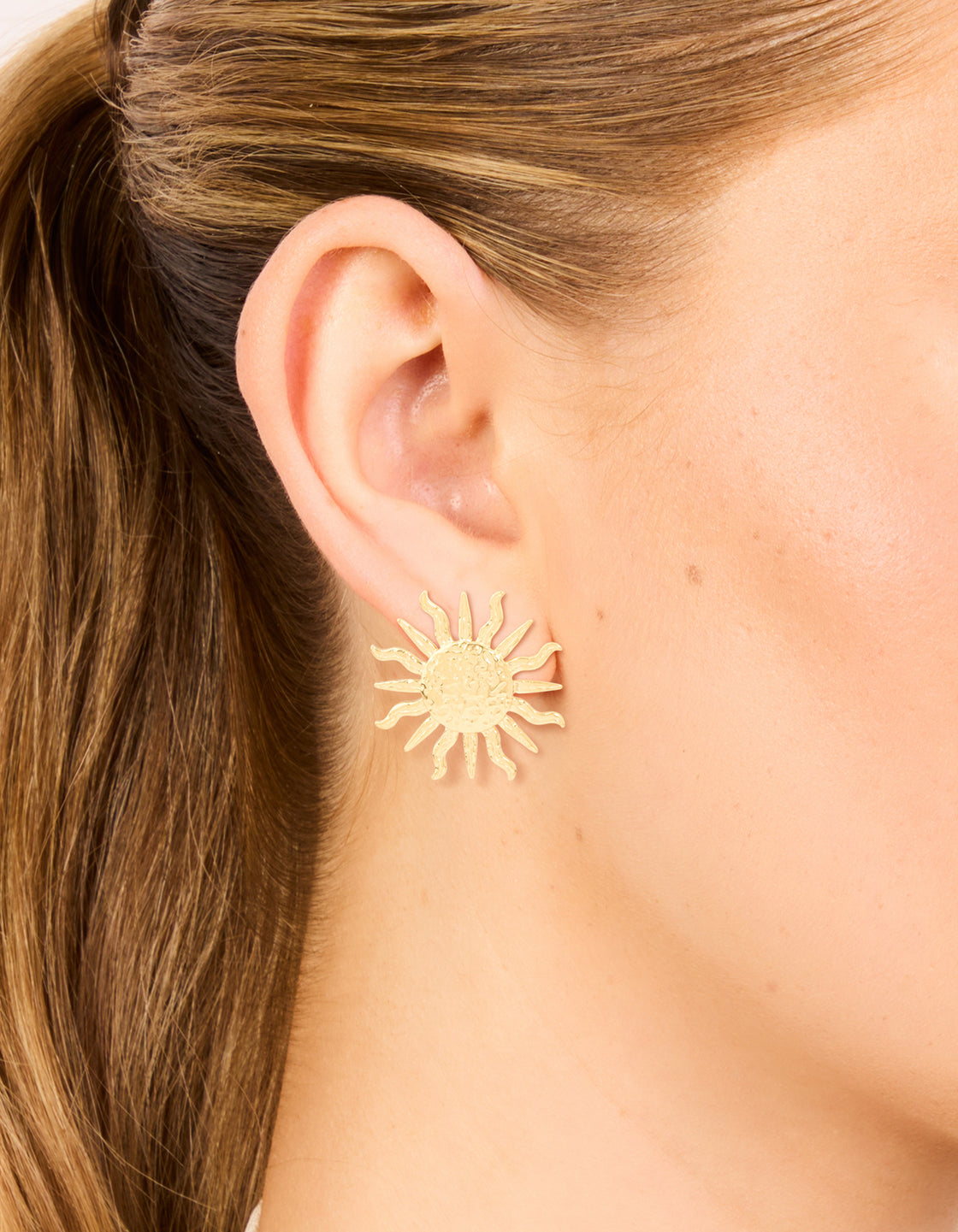 Featuring waterproof gold plated stainless steel sun statement stud earrings with celestial design on ear view