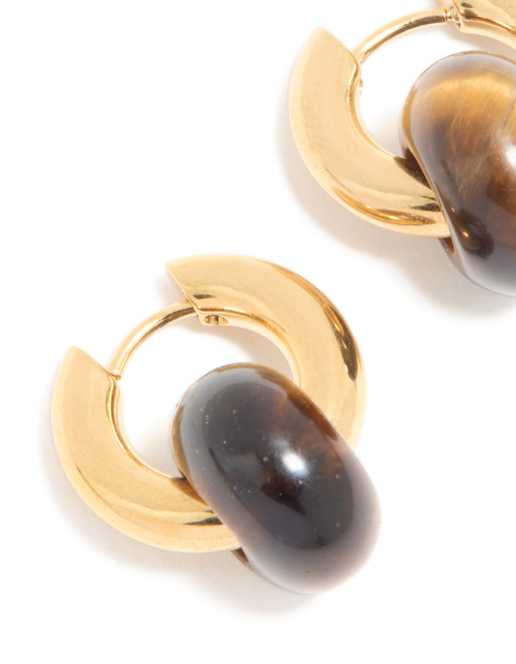 Displaying dainty huggie earrings in waterproof gold plated stainless steel and semi precious tiger's eye stone close up view