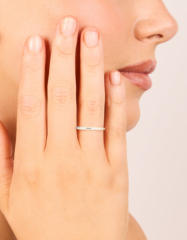 Crafted from sterling silver, this molten ring on finger view