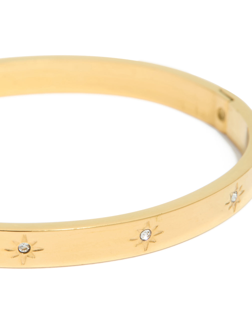 Highlighting a waterproof gold plated stainless steel celestial cubic zirconia hinged sunburst statement bangle close up view