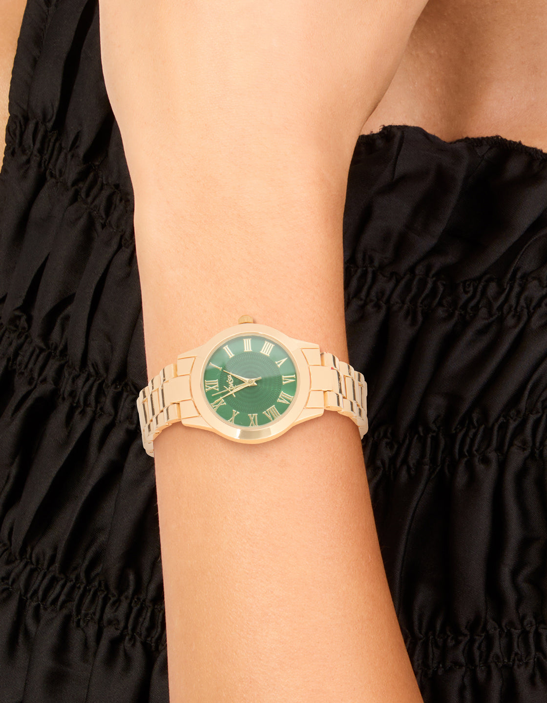 Crafted with gold link band strap, this statement watch features green dial with roman numerals, designed for women and formal occasions on wrist view