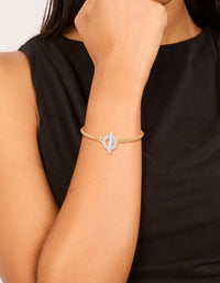 Showcasing a mixed metal silver plated T and O chain bracelet with gold plated links and cubic zirconia toggle closure on wrist view - link has visual effect only