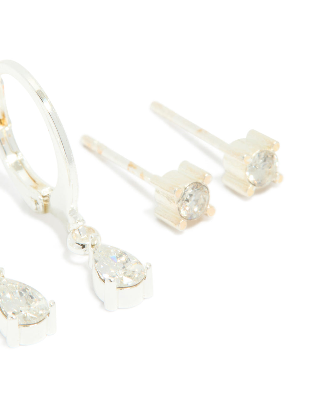 Highlighting waterproof stainless steel cubic zirconia simple stud and huggie earrings in a 3-pack and silver finish post detail view