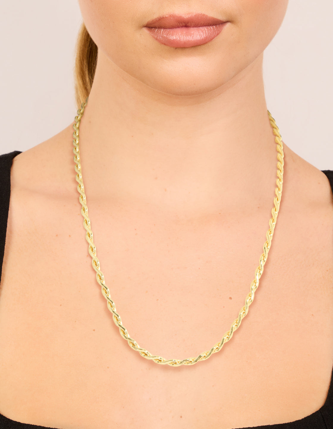 Showcasing a waterproof teardrop chain link necklace crafted from gold plated stainless steel on neck view