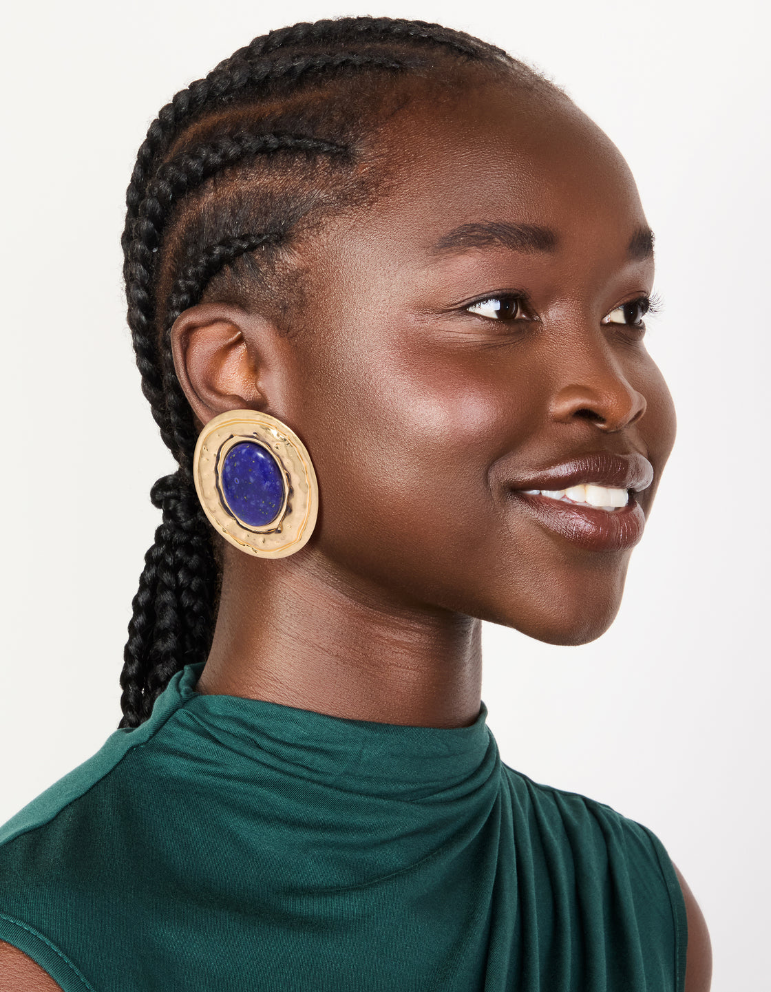 Crafted from worn gold with round hammered dark blue acrylic stud earrings in statement style on model view