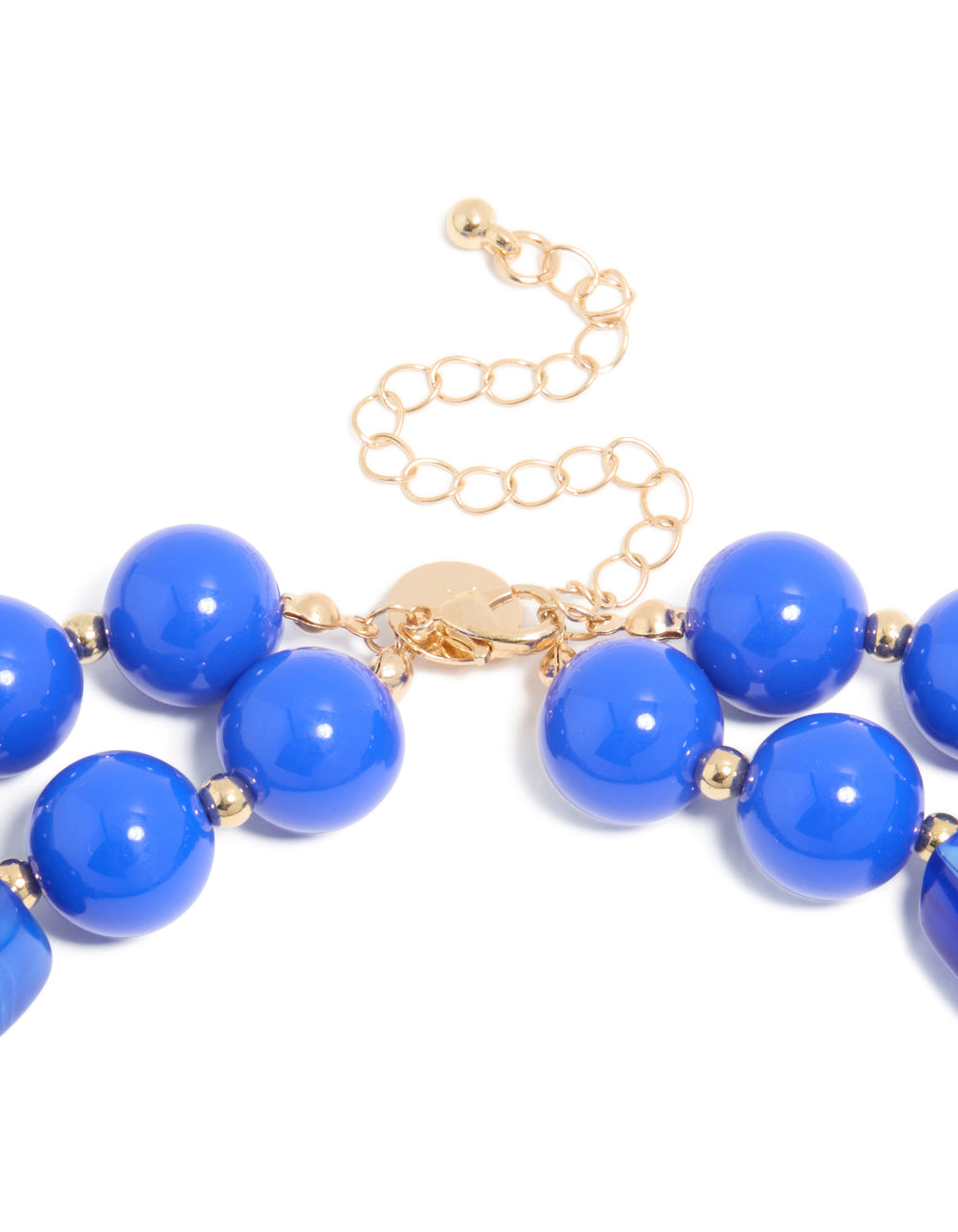 Displaying a dark blue acrylic beaded long layered necklace with balls and statement style in royal and dodger blue with gold accents clasp detail view
