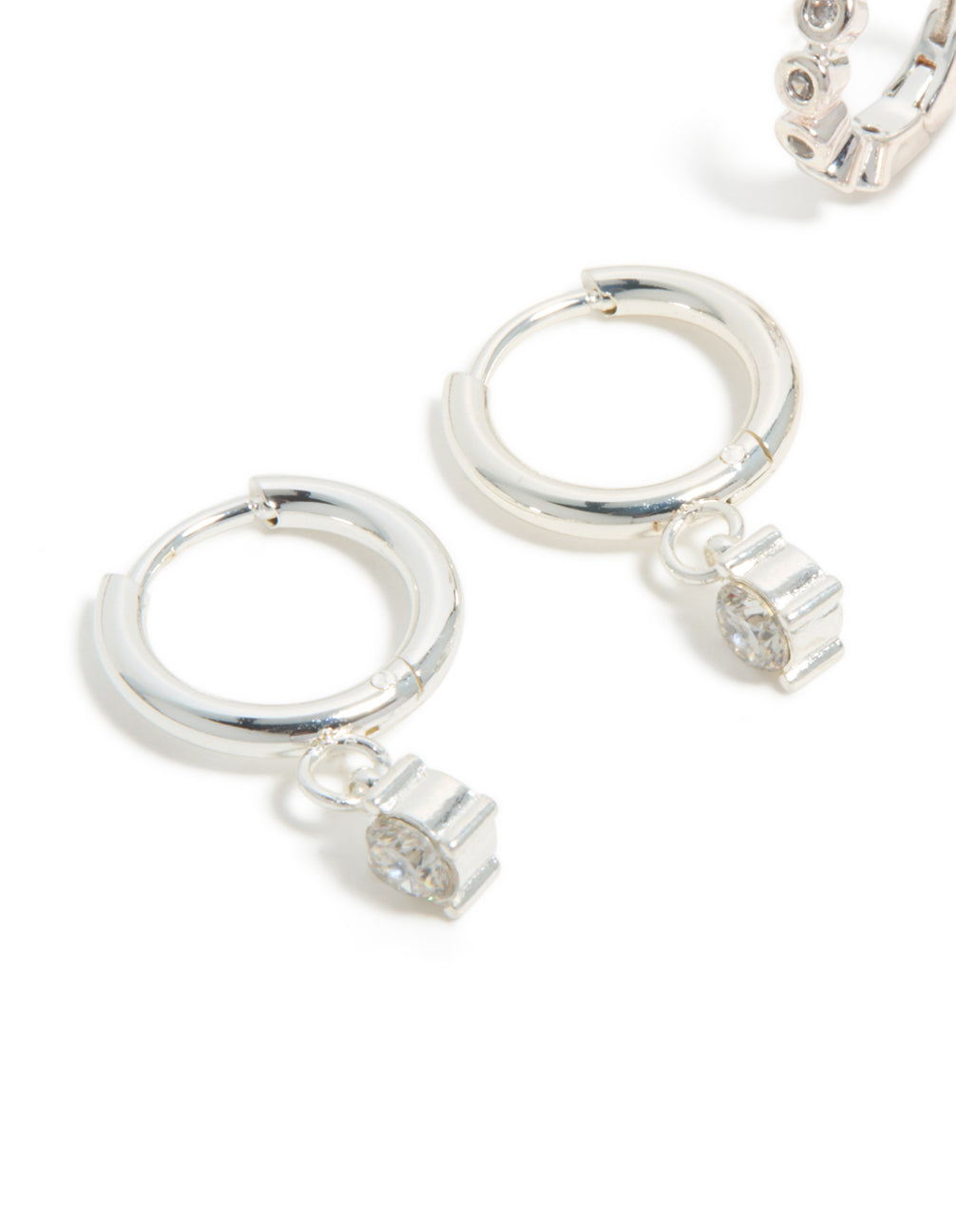 Crafted from waterproof stainless steel bezel diamante and plain huggie earrings 2-pack with charm in silver and white close up