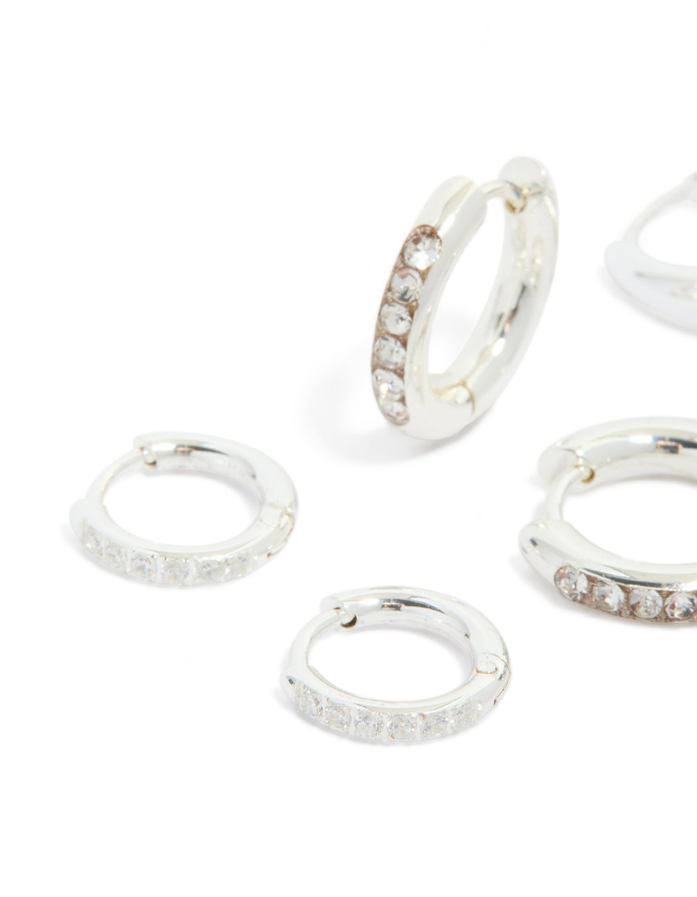 Showcasing waterproof stainless steel basic, pavé and plain huggie earrings with cubic zirconia in silver 3-pack close up view