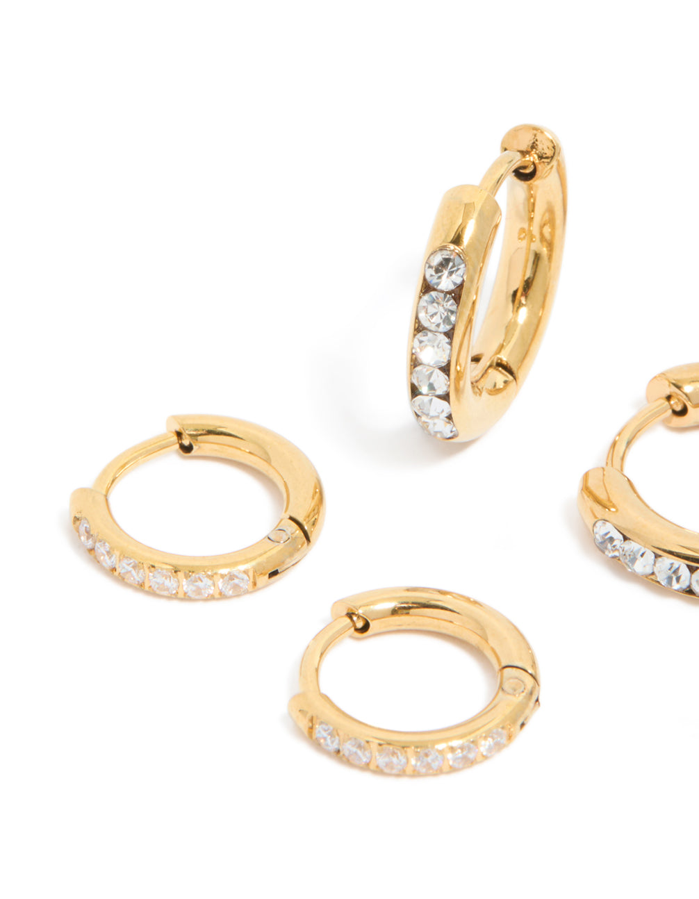 Crafted from waterproof stainless steel, these pavé and plain huggie earrings with gold plating in a 3-pack set with a close up view