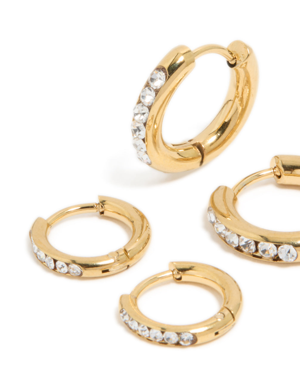 Highlighting waterproof gold plated stainless steel cubic zirconia huggie earrings in a 2-pack with crystal and hoop closure close up view