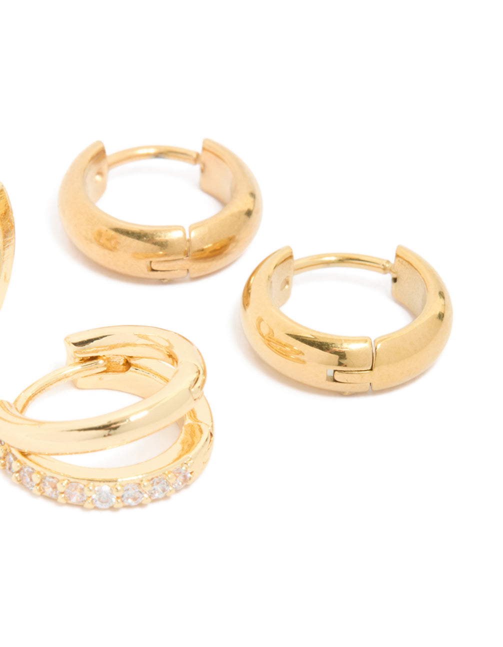 Designed with waterproof chunky diamante huggie earrings in a 2-pack, crafted from stainless steel featuring cubic zirconia crystals and gold plating in a post detail view